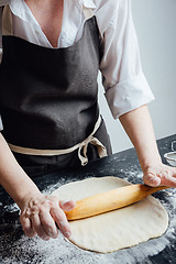 Image showing Person rolling homemade cookie dough