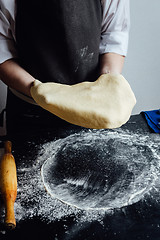 Image showing Person rolling homemade cookie dough