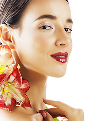 Image showing young pretty brunette woman with red flower amaryllis close up i