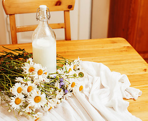 Image showing Simply stylish wooden kitchen with bottle of milk and glass on t