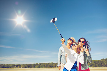 Image showing group of smiling women taking selfie on beach