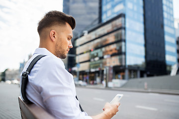 Image showing man with smartphone and bicycle in city