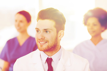 Image showing happy doctor over group of medics at hospital