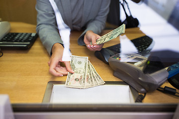 Image showing clerk giving cash money to customer at bank office