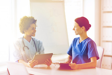 Image showing happy doctors with tablet pc meeting at hospital