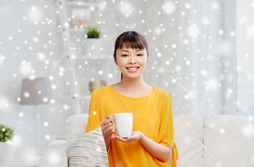 Image showing happy asian woman drinking from tea cup