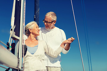 Image showing happy senior couple on sail boat or yacht in sea