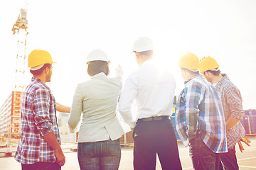 Image showing group of builders and architects at building site