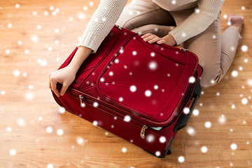 Image showing close up of woman packing travel bag for vacation