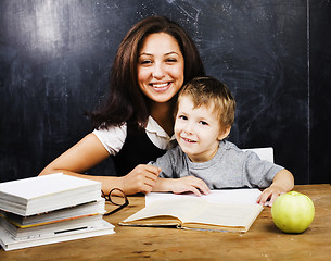 Image showing little cute boy with teacher in classroom