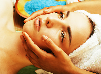 Image showing stock photo attractive lady getting spa treatment in salon, close up asian hands on face