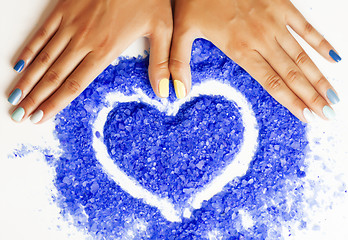Image showing manicure with blue nails and seasalt close up like heart, love f