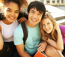 Image showing cute group of teenages at the building of university with books huggings, back to school