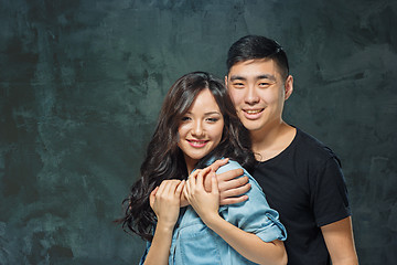 Image showing Portrait of smiling Korean couple on a gray