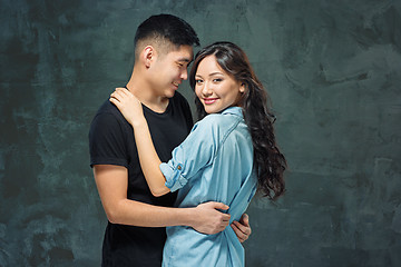 Image showing Portrait of smiling Korean couple on a gray