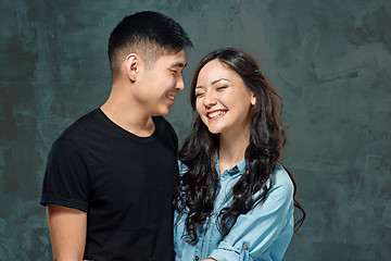 Image showing Portrait of smiling Korean couple on a gray