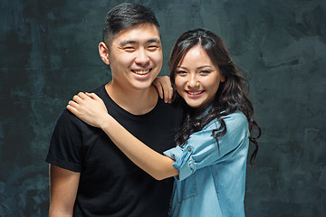 Image showing Portrait of smiling Korean couple on a gray