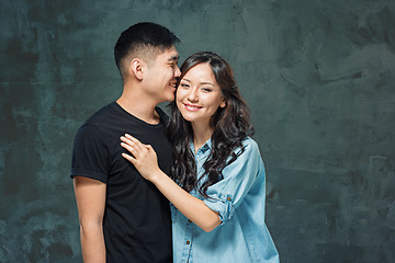 Image showing Portrait of smiling Korean couple on a gray