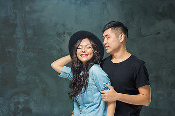 Image showing Portrait of smiling Korean couple on a gray