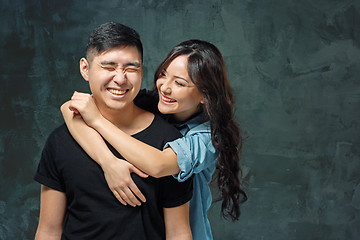 Image showing Portrait of smiling Korean couple on a gray