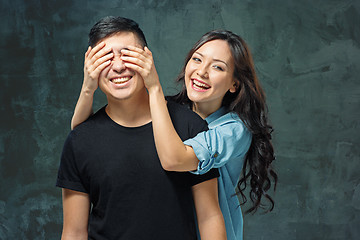 Image showing Portrait of smiling Korean couple on a gray