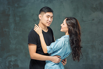 Image showing Portrait of smiling Korean couple on a gray