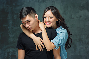 Image showing Portrait of smiling Korean couple on a gray