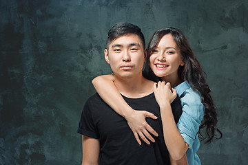 Image showing Portrait of smiling Korean couple on a gray