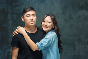 Image showing Portrait of smiling Korean couple on a gray