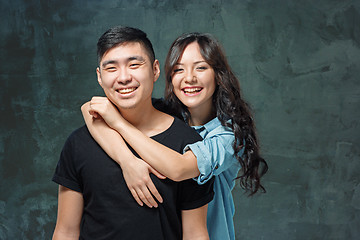 Image showing Portrait of smiling Korean couple on a gray