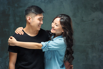 Image showing Portrait of smiling Korean couple on a gray