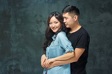 Image showing Portrait of smiling Korean couple on a gray