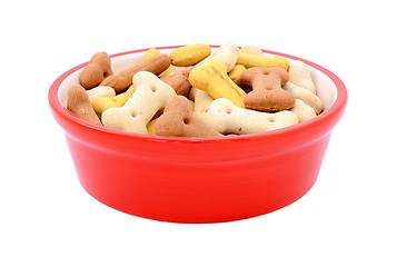Image showing Dry bone-shaped dog biscuits in a red pet food bowl