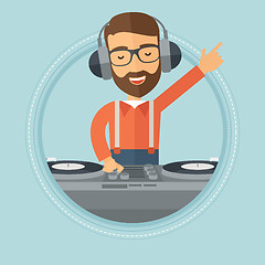 Image showing Smiling DJ mixing music on turntables.