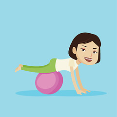 Image showing Young woman exercising with fitball.