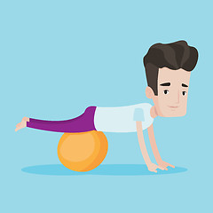 Image showing Young man exercising with fitball.