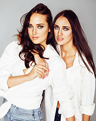 Image showing two sisters twins posing, making photo selfie, dressed same whit