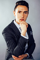 Image showing young pretty business man standing on white background, modern hairstyle, posing emotional, lifestyle people concept