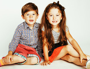 Image showing little cute boy and girl hugging playing on white background, ha