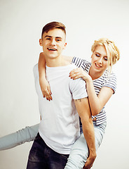 Image showing young pretty teenage couple, hipster guy with his girlfriend happy smiling and hugging isolated on white background, lifestyle people concept