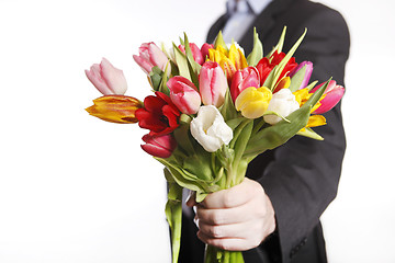 Image showing Male hand with bouquet of tulips, isolated