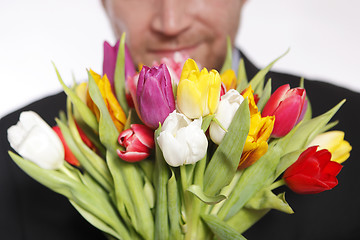 Image showing Male hand with bouquet of tulips, isolated