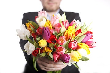 Image showing Male hand with bouquet of tulips, isolated