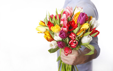 Image showing Male hand with bouquet of tulips, isolated