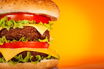 Image showing Tasty and appetizing hamburger on a yellow