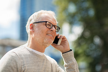 Image showing happy senior man calling on smartphone in city