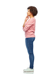 Image showing thinking african american young woman over white