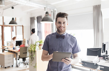 Image showing happy creative male office worker with tablet pc