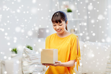 Image showing happy asian young woman with parcel box at home