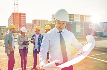 Image showing architect with blueprint on construction site